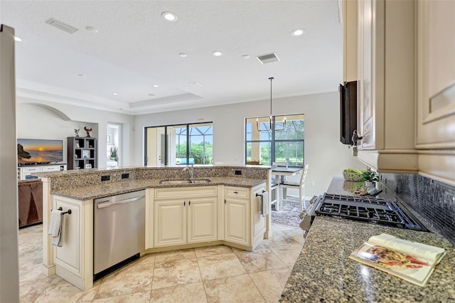 12710 Stone Ridge Pl, Lakewood Ranch, FL 34202 - kitchen featuring dishwasher, cream cabinets, a sink, crown molding, and dark stone counters