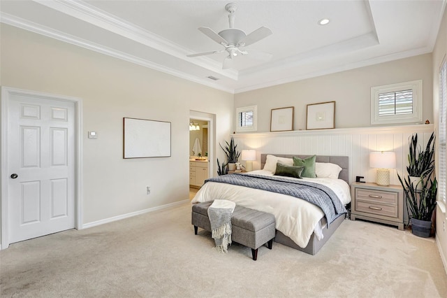 12710 Stone Ridge Pl, Lakewood Ranch, FL 34202 - carpeted bedroom featuring a raised ceiling, ornamental molding, ceiling fan, ensuite bathroom, and baseboards