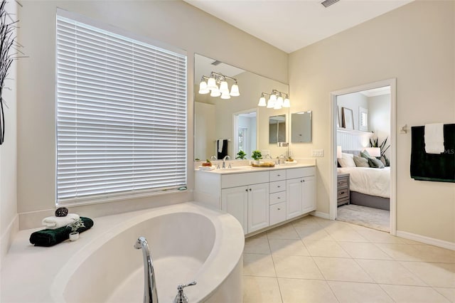12710 Stone Ridge Pl, Lakewood Ranch, FL 34202 - bathroom featuring double vanity, a garden tub, tile patterned flooring, connected bathroom, and baseboards
