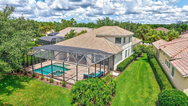 12710 Stone Ridge Pl, Lakewood Ranch, FL 34202 - view of swimming pool featuring a patio, a lawn, a pool with connected hot tub, and glass enclosure