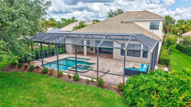 12710 Stone Ridge Pl, Lakewood Ranch, FL 34202 - view of pool with a patio area, a yard, glass enclosure, and a pool with connected hot tub