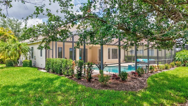 12710 Stone Ridge Pl, Lakewood Ranch, FL 34202 - rear view of house with stucco siding, an outdoor pool, and a lawn