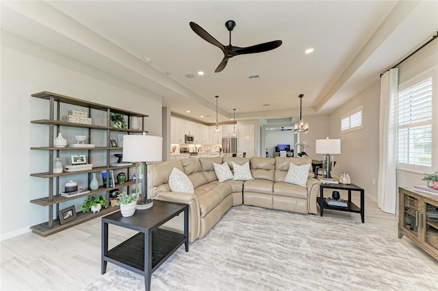 909 Crosswind Ave, Sarasota, FL 34240 - living area featuring a ceiling fan, recessed lighting, baseboards, a tray ceiling, and a chandelier