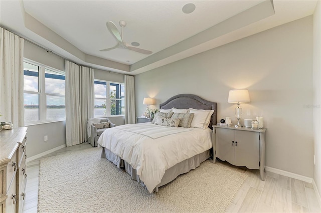 909 Crosswind Ave, Sarasota, FL 34240 - bedroom with baseboards, a tray ceiling, and ceiling fan
