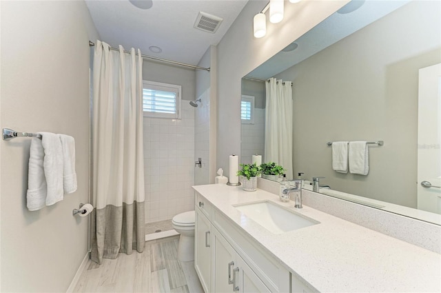909 Crosswind Ave, Sarasota, FL 34240 - full bathroom with toilet, vanity, a tile shower, and baseboards