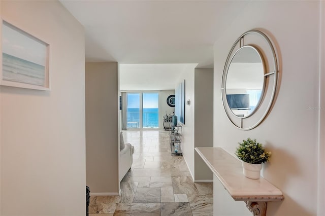 2425 Gulf Of Mexico Dr Unit 14B, Longboat Key, FL 34228 - hallway featuring baseboards and light marble finish flooring