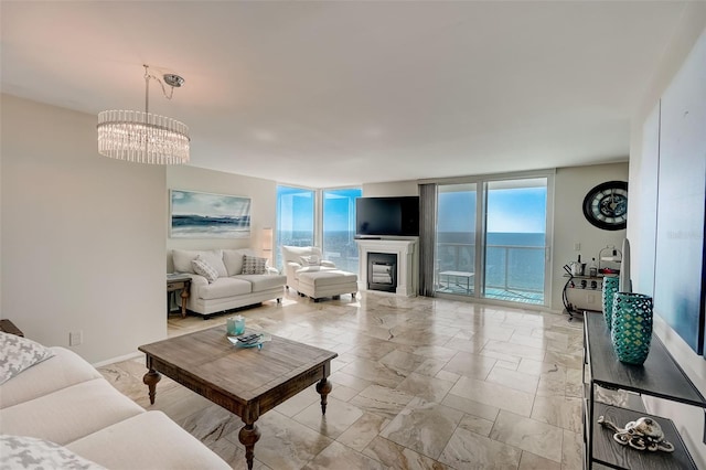 2425 Gulf Of Mexico Dr Unit 14B, Longboat Key, FL 34228 - living area with a chandelier, a wall of windows, and light marble finish flooring