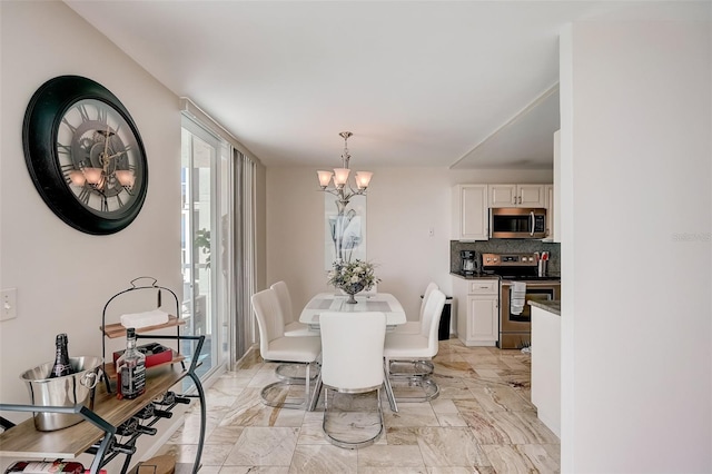 2425 Gulf Of Mexico Dr Unit 14B, Longboat Key, FL 34228 - dining area featuring a chandelier and light marble finish floors