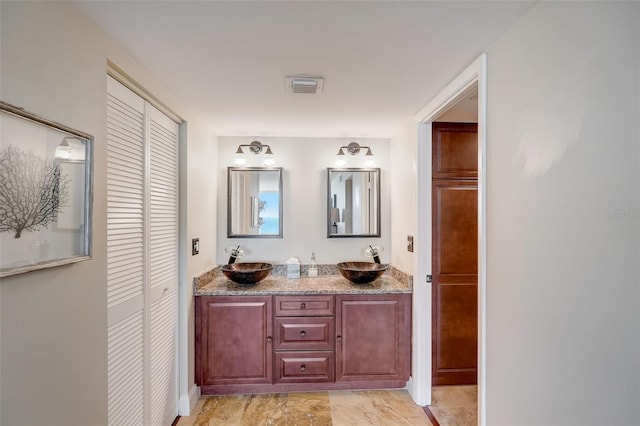 2425 Gulf Of Mexico Dr Unit 14B, Longboat Key, FL 34228 - bathroom featuring a closet and double vanity
