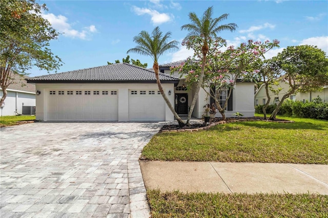 6140 Bobby Jones Ct, Palmetto, FL 34221 - view of front of property with stucco siding, decorative driveway, a tiled roof, and a front lawn
