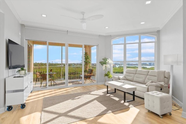 5450 Eagles Point Cir Unit 404, Sarasota, FL 34231 - living area with ornamental molding, wood finished floors, baseboards, and ceiling fan