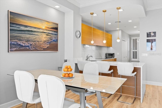 5450 Eagles Point Cir Unit 404, Sarasota, FL 34231 - dining room featuring baseboards, crown molding, light wood-style floors, and recessed lighting