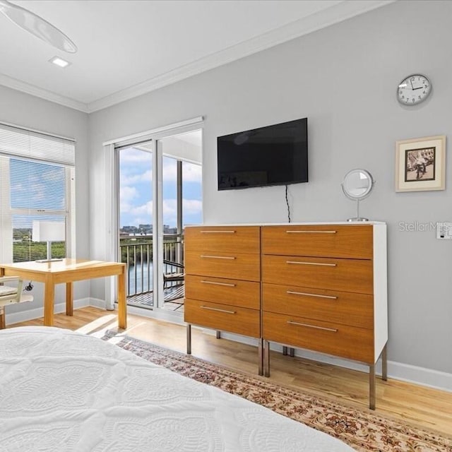 5450 Eagles Point Cir Unit 404, Sarasota, FL 34231 - bedroom featuring light wood finished floors, access to outside, crown molding, and baseboards