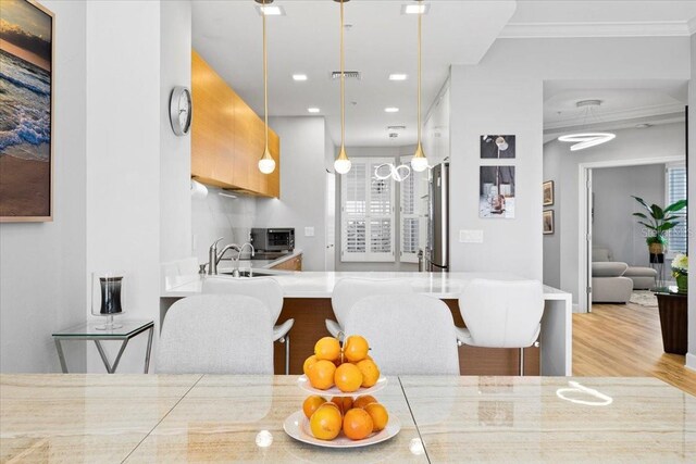5450 Eagles Point Cir Unit 404, Sarasota, FL 34231 - dining area featuring wood finished floors, plenty of natural light, recessed lighting, and ornamental molding