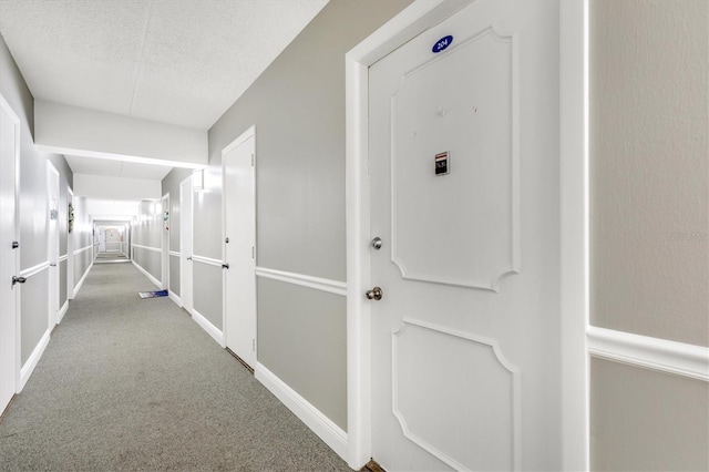 3806 Gulf Of Mexico Dr Unit C204, Longboat Key, FL 34228 - hallway with carpet floors, a textured ceiling, and baseboards