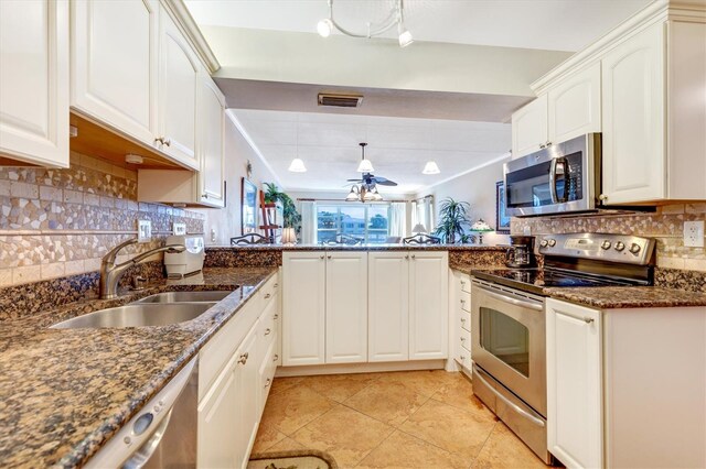 3806 Gulf Of Mexico Dr Unit C204, Longboat Key, FL 34228 - kitchen featuring appliances with stainless steel finishes, a sink, decorative backsplash, dark stone countertops, and light tile patterned floors