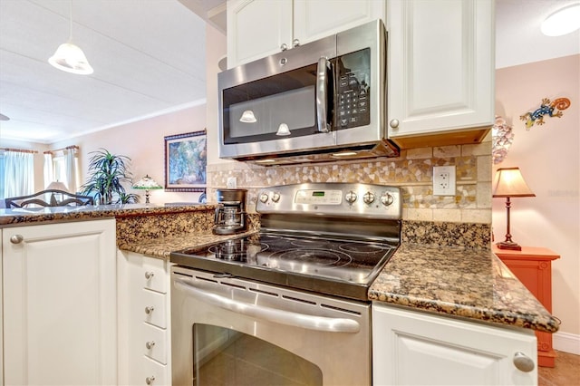 3806 Gulf Of Mexico Dr Unit C204, Longboat Key, FL 34228 - kitchen featuring stainless steel appliances, backsplash, white cabinetry, dark stone counters, and a peninsula