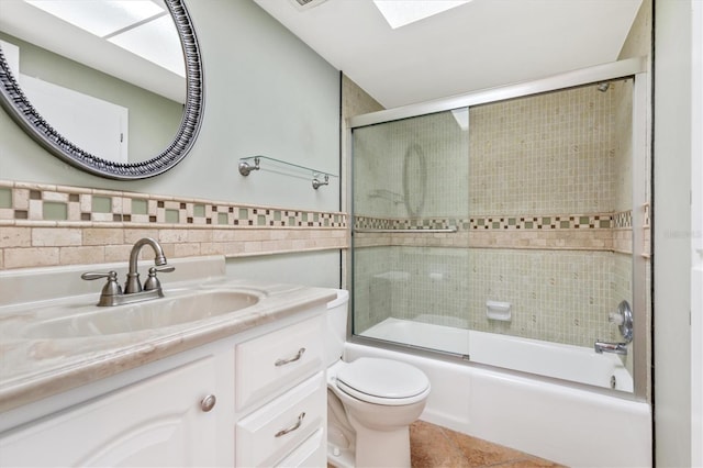 3806 Gulf Of Mexico Dr Unit C204, Longboat Key, FL 34228 - bathroom featuring toilet, vanity, tile walls, combined bath / shower with glass door, and tile patterned flooring