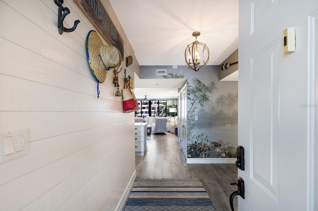 1445 Gulf Of Mexico Dr Unit 203, Longboat Key, FL 34228 - hallway with a chandelier and wood finished floors