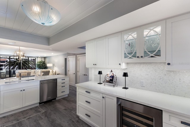 1445 Gulf Of Mexico Dr Unit 203, Longboat Key, FL 34228 - kitchen featuring stainless steel dishwasher, beverage cooler, dark wood-style floors, white cabinets, and tasteful backsplash