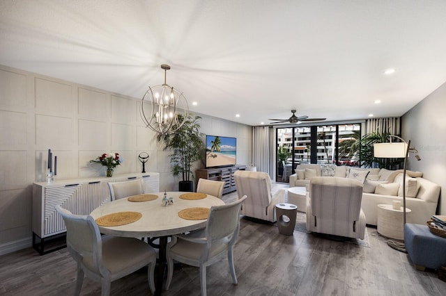 1445 Gulf Of Mexico Dr Unit 203, Longboat Key, FL 34228 - dining area with dark wood-style floors, a ceiling fan, a chandelier, and a decorative wall
