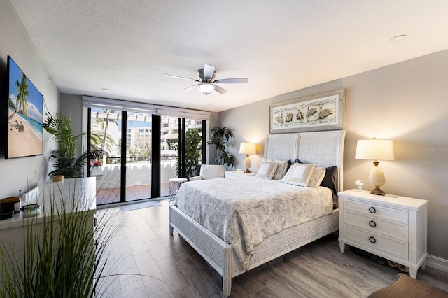 1445 Gulf Of Mexico Dr Unit 203, Longboat Key, FL 34228 - bedroom with access to exterior, wood finished floors, and ceiling fan