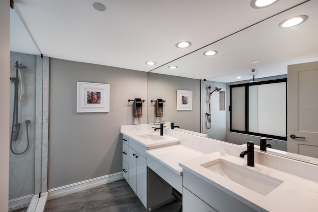 1445 Gulf Of Mexico Dr Unit 203, Longboat Key, FL 34228 - full bathroom featuring a stall shower, double vanity, recessed lighting, and wood finished floors