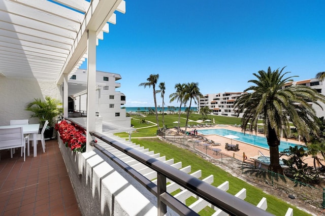 1445 Gulf Of Mexico Dr Unit 203, Longboat Key, FL 34228 - balcony featuring view of pool area, outdoor dining space, and a water view