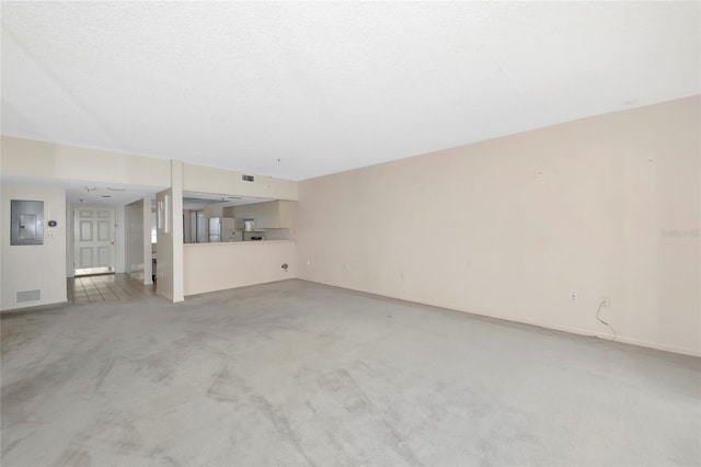 3630 Gulf Of Mexico Dr Unit 202, Longboat Key, FL 34228 - unfurnished living room featuring electric panel, light colored carpet, and baseboards