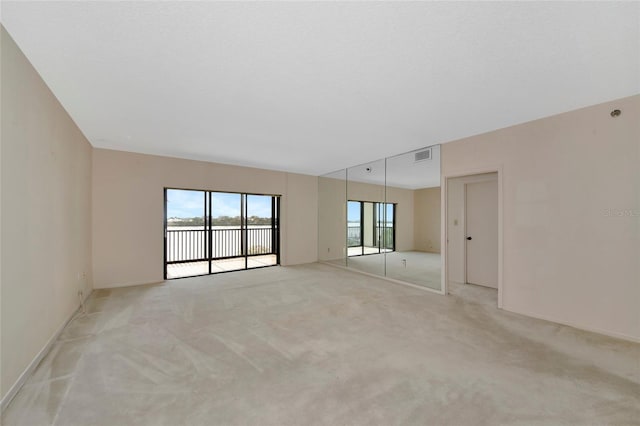 3630 Gulf Of Mexico Dr Unit 202, Longboat Key, FL 34228 - unfurnished room featuring light carpet, a water view, and baseboards