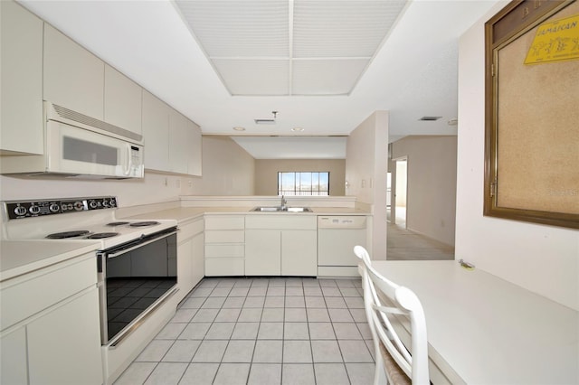3630 Gulf Of Mexico Dr Unit 202, Longboat Key, FL 34228 - kitchen with white appliances, a sink, light countertops, and light tile patterned flooring