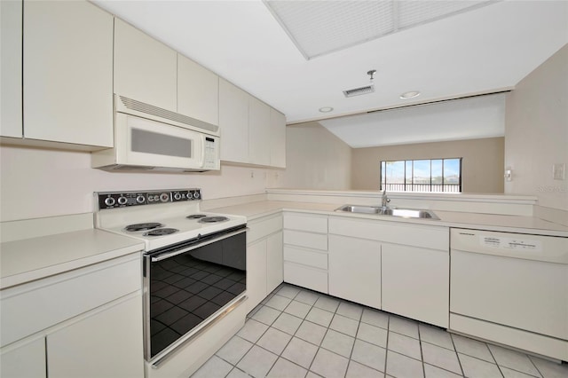 3630 Gulf Of Mexico Dr Unit 202, Longboat Key, FL 34228 - kitchen featuring white appliances, a sink, light countertops, light tile patterned flooring, and white cabinets