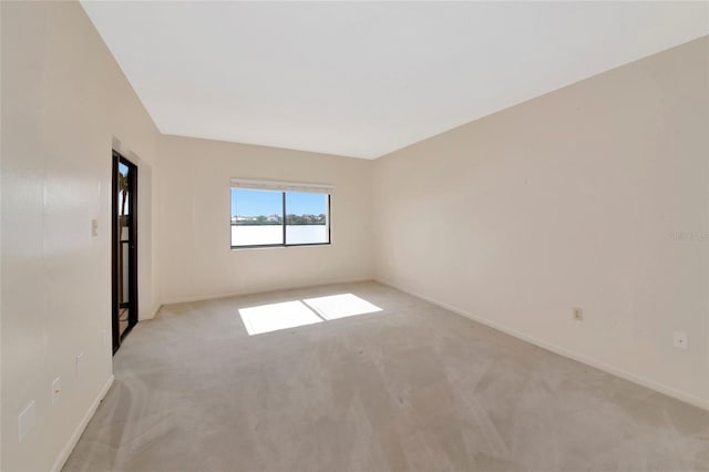 3630 Gulf Of Mexico Dr Unit 202, Longboat Key, FL 34228 - empty room with light carpet and baseboards