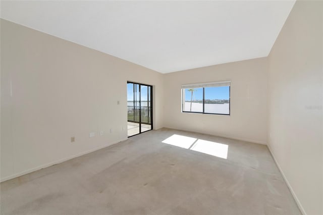 3630 Gulf Of Mexico Dr Unit 202, Longboat Key, FL 34228 - carpeted spare room featuring baseboards