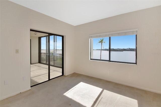 3630 Gulf Of Mexico Dr Unit 202, Longboat Key, FL 34228 - unfurnished room featuring carpet, baseboards, and a water view