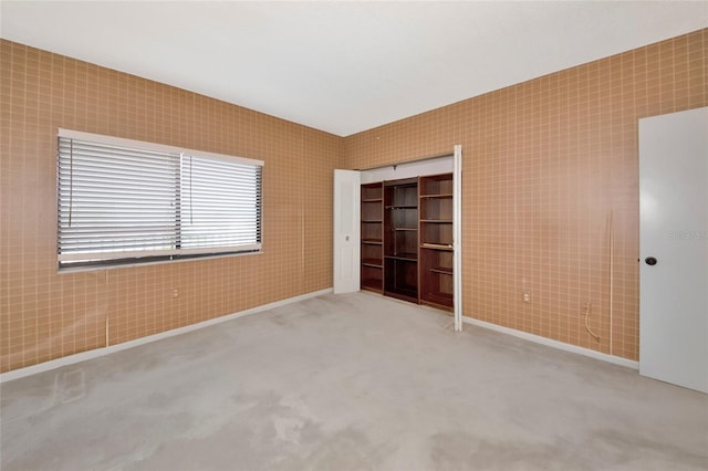 3630 Gulf Of Mexico Dr Unit 202, Longboat Key, FL 34228 - unfurnished bedroom with baseboards, a closet, and carpet flooring
