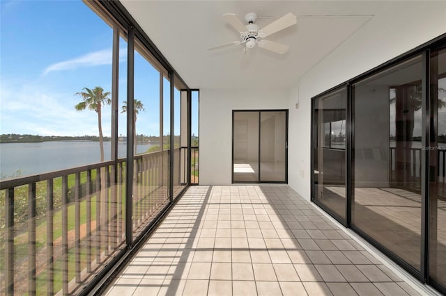 3630 Gulf Of Mexico Dr Unit 202, Longboat Key, FL 34228 - unfurnished sunroom featuring a water view, ceiling fan, tile patterned floors, and floor to ceiling windows