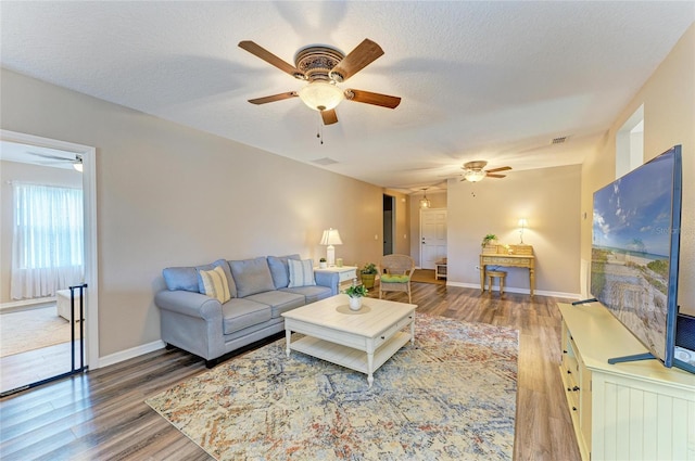 7410 61st St E, Palmetto, FL 34221 - living room with a ceiling fan, wood finished floors, and a textured ceiling