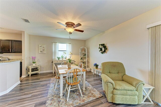 7410 61st St E, Palmetto, FL 34221 - dining space with ceiling fan, wood finished floors, and a textured ceiling