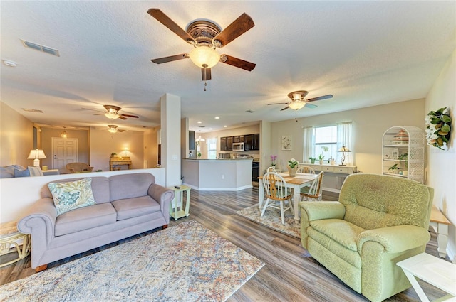 7410 61st St E, Palmetto, FL 34221 - living room featuring a ceiling fan, wood finished floors, and a textured ceiling