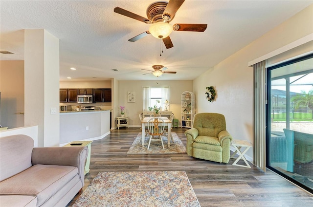 7410 61st St E, Palmetto, FL 34221 - living room featuring wood finished floors, ceiling fan, recessed lighting, and a textured ceiling