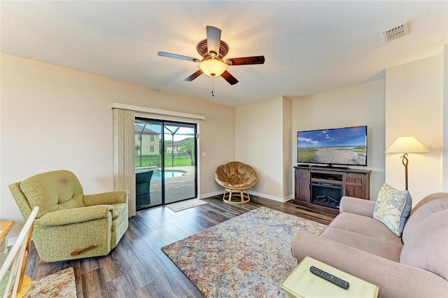 7410 61st St E, Palmetto, FL 34221 - living area with ceiling fan and dark wood-style flooring