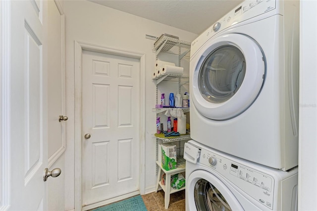 7410 61st St E, Palmetto, FL 34221 - washroom featuring stacked washer / drying machine and tile patterned flooring