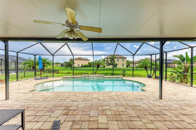 7410 61st St E, Palmetto, FL 34221 - outdoor pool featuring glass enclosure, a patio area, ceiling fan, and a lawn