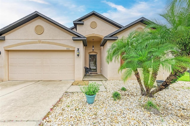 7410 61st St E, Palmetto, FL 34221 - view of front of home featuring stucco siding, concrete driveway, and an attached garage
