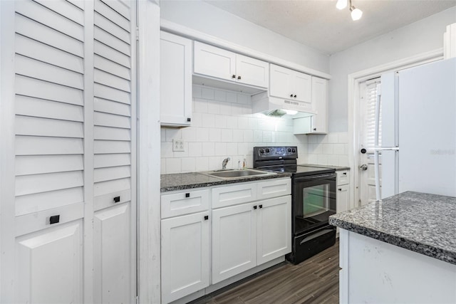 4507 9th St W Unit A2, Bradenton, FL 34207 - kitchen featuring electric range, under cabinet range hood, dark wood-style floors, white cabinets, and decorative backsplash