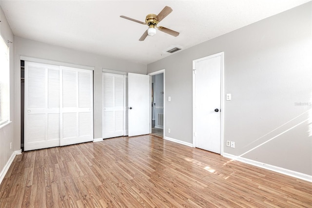 4507 9th St W Unit A2, Bradenton, FL 34207 - unfurnished bedroom with multiple closets, light wood-style flooring, and a ceiling fan