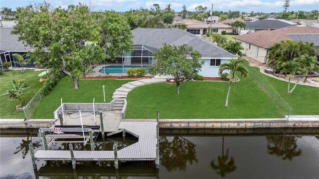 1314 SE 15th Ter, Cape Coral, FL 33990 - dock with boat lift, a water view, a lawn, a lanai, and an outdoor pool