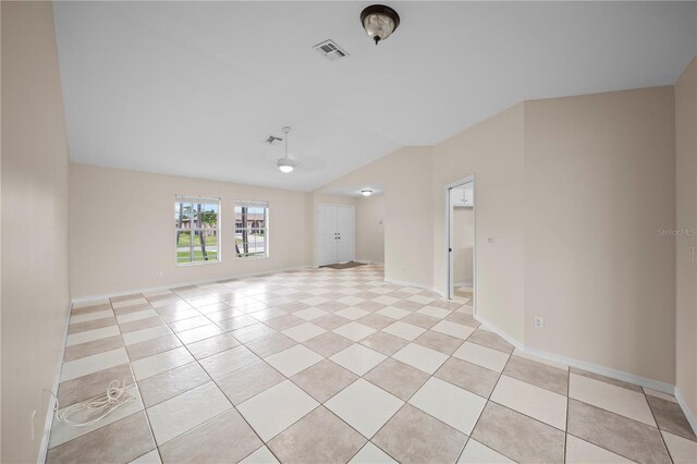 1314 SE 15th Ter, Cape Coral, FL 33990 - spare room with vaulted ceiling, light tile patterned floors, and baseboards