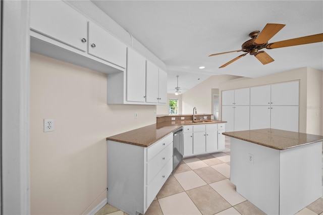 1314 SE 15th Ter, Cape Coral, FL 33990 - kitchen featuring a sink, stainless steel dishwasher, a peninsula, ceiling fan, and dark stone counters
